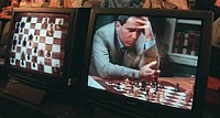 An audience watches as Garry Kasparov is shown on a television screen contemplating his next move against Deep Blue, IBM's chess playing computer, during the second game of their six game rematch, Sunday, May 4, 1997, in New York.  It was Man 1, Machine 0, after world chess champion Kasparov won the first game of the rematch on Saturday. (AP Photo/Adam Nadel)(Click the thumbnail to see the original image)